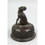 A BRONZE OKIMONO OF A MYTHOLOGICAL BEAST, atop a pierced koro cover, 12.5cm.