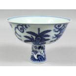 A CHINESE BLUE AND WHITE PORCELAIN STEM CUP, the exterior decorated with female figures in a