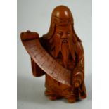 A SMALL JAPANESE CARVED WOOD FIGURE of a sage holding a scroll, 6cm high.