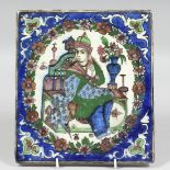 A PERSIAN GLAZED POTTERY TILE, central depicting a seated figure within a floral border, 24cm x 21.