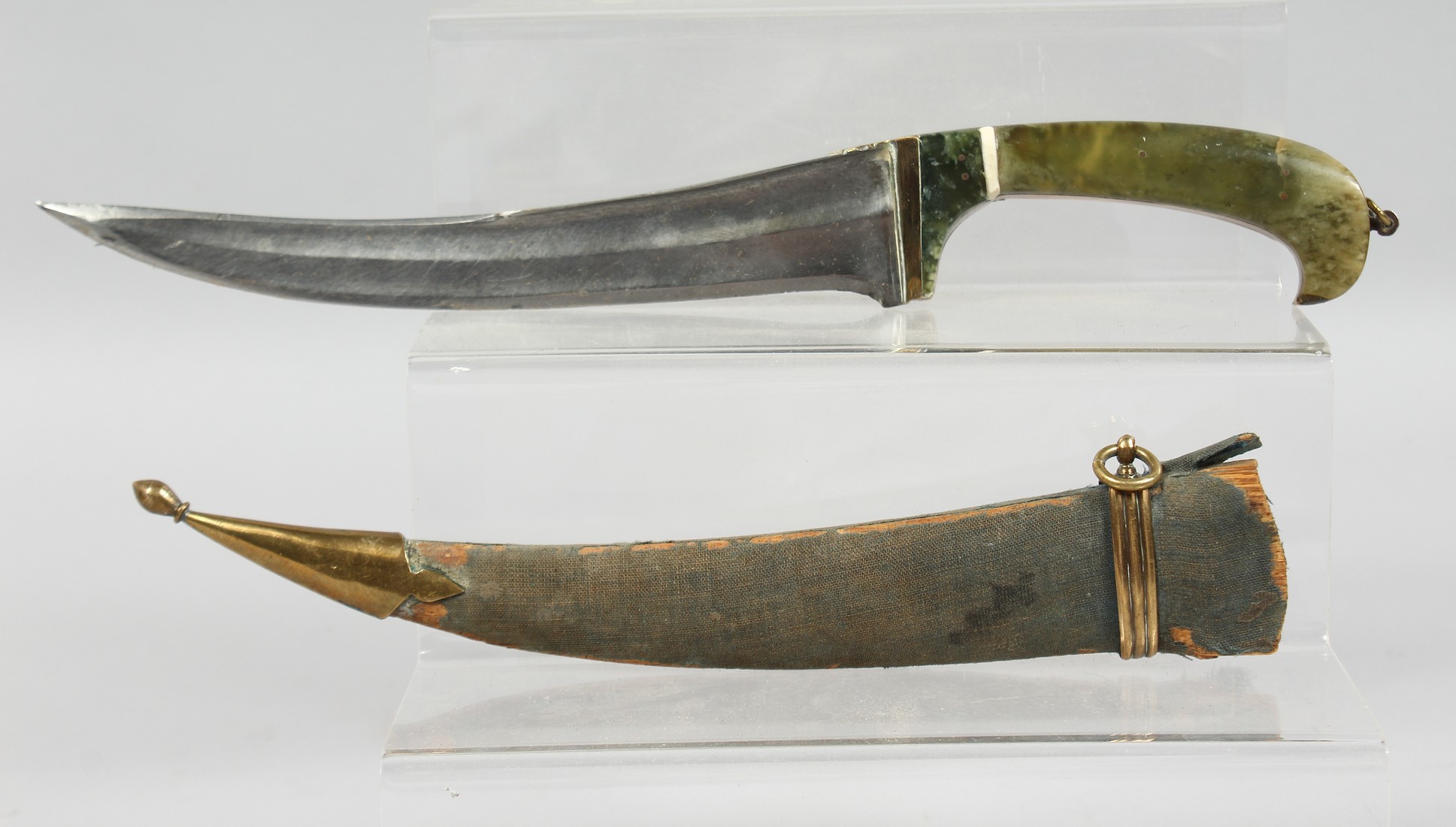 AN INDIAN JADE HANDLED DAGGER, with curving blade and wooden sheath, 35cm long overall.