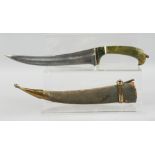 AN INDIAN JADE HANDLED DAGGER, with curving blade and wooden sheath, 35cm long overall.