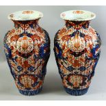 A LARGE PAIR OF JAPANESE IMARI PORCELAIN VASES, each with ribbed body and raised dragon