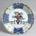 A JAPANESE IMARI PORCELAIN DISH, decorated in blue and white with central vase of flowers. 27cm