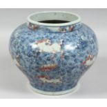 A CHINESE BLUE, WHITE, AND UNDERGLAZE RED PORCELAIN JAR, decorated with horses amongst stylised