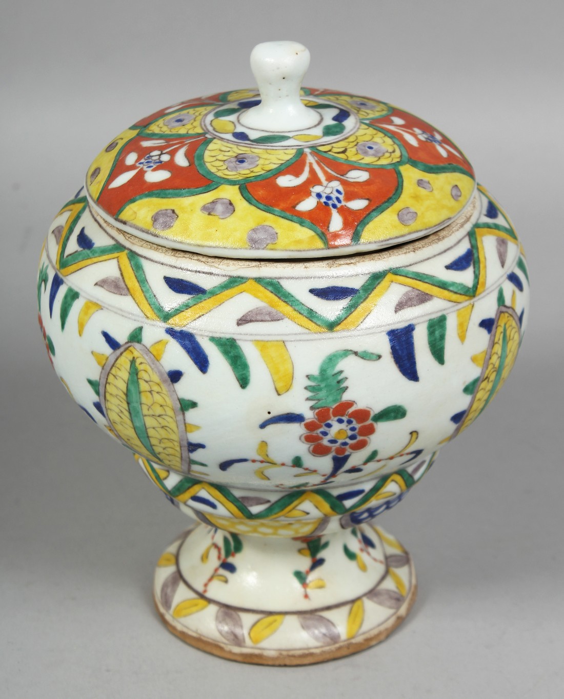 A TURKISH KUTAHYA POTTERY PEDESTAL SUGAR BOWL AND COVER, painted with various floral motifs, overall