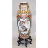 A LARGE CHINESE FLOOR STANDING PORCELAIN VASE on a hardwood stand, decorated in Japanese style