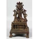 A GOOD SEATED BRONZE DEITY, raised on a plinth, supported by four legs. 24cm high