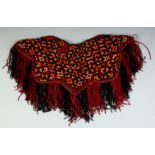 A TURKAMAN BABY PONCHO, all over embroidered design with fringed edge, approx. 37cm diameter.
