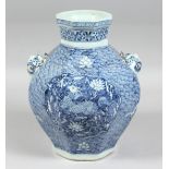 A CHINESE BLUE AND WHITE PORCELAIN OCTAGONAL TWIN-HANDLED VASE, each side decorated with a panel