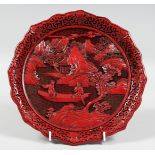 A CHINESE CINNABAR LACQUER DISH, depicting a scene with female figures in a boat, 24.5cm diameter.