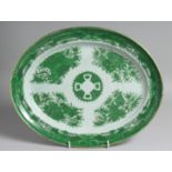 A CHINESE EXPORT PORCELAIN GREEN FITZHUGH OVAL-SHAPED DISH decorated with flora, objects, and