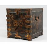 A JAPANESE MEIJI PERIOD BLACK LACQUER TABLE CABINET, the doors opening to reveal seven lacquered