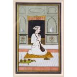 AN INDIAN MINIATURE PAINTING depicting a seated prince holding a sitar, image size 18cm x 11cm.