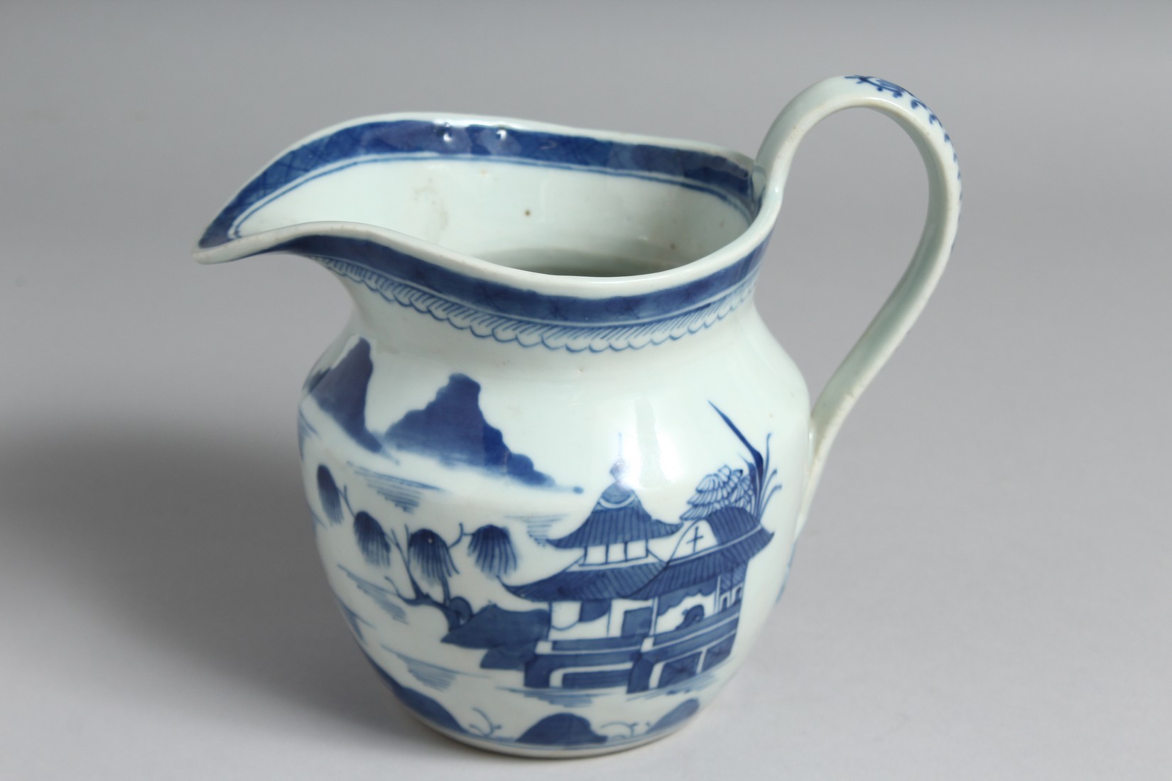 A CHINESE BLUE AND WHITE PORCELAIN JUG decorated with a landscape scene with boats and buildings. - Image 3 of 5