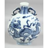 A CHINESE BLUE AND WHITE PORCELAIN TWIN-HANDLED MOON FLASK, the body painted with large dragon and