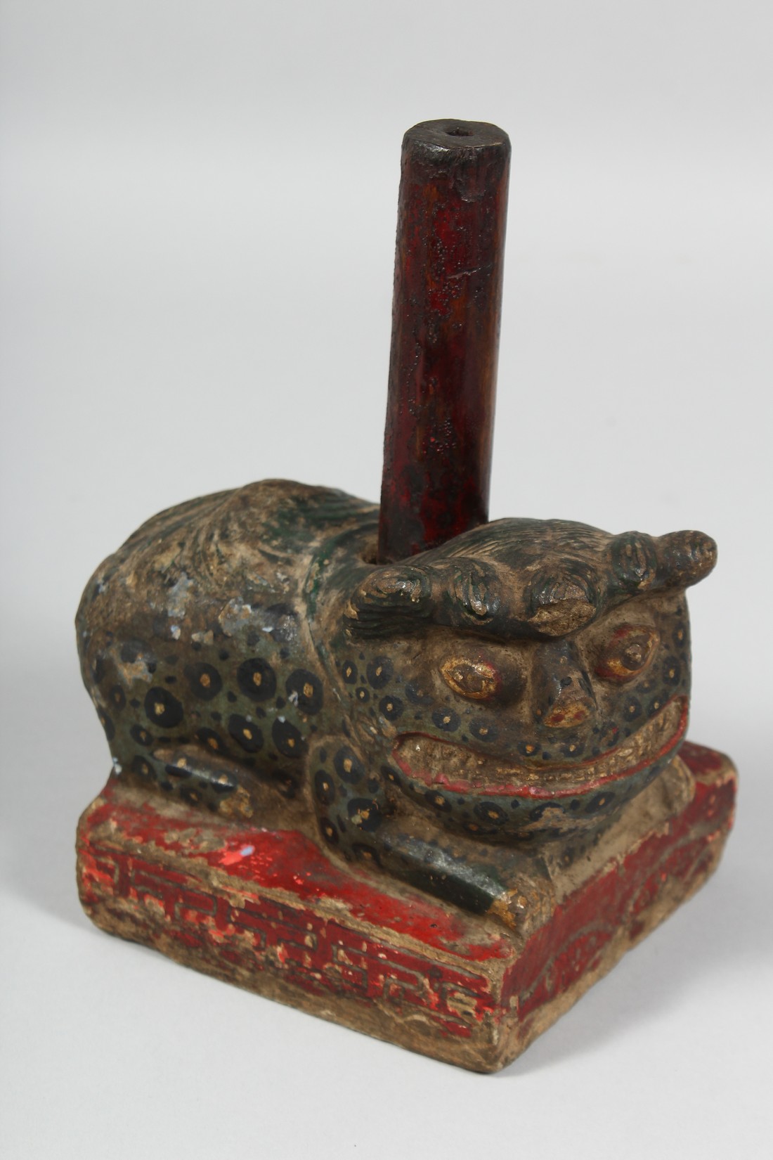 A CHINESE CARVED AND PAINTED STONE FIGURE OF A TEMPLE GUARDIAN, 15cm long.