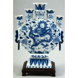 A CONTEMPORARY CHINESE BLUE AND WHITE PORCELAIN TULIP VASE AND STAND, central painted with a dragon,