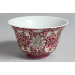 A CHINESE PINK GROUND PORCELAIN ENAMELLED BOWL with stylised floral motifs and vine, the base with