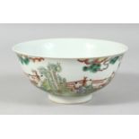 A CHINESE FAMILLE VERTE PORCELAIN BOWL decorated with children in a garden, the base with a six-
