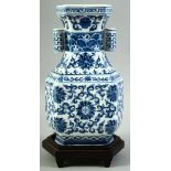 A CONTEMPORARY CHINESE BLUE AND WHITE PORCELAIN TULIP VASE AND STAND, painted with foliate design,