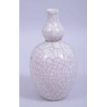 A CHINESE KANGXI PERIOD GUAN GLAZE DOUBLE GOURD PORCELAIN VASE, with a small museum repair to