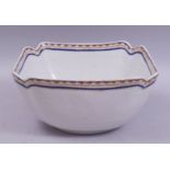 A CHINESE / EUROPEAN SQUARE FORM PORCELAIN BOWL, with red, blue and gilt work rim, 25.5cm diameter.
