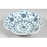 A CHINESE BLUE AND WHITE PETAL-FORMED PORCELAIN DISH, the interior decorated with lotus and