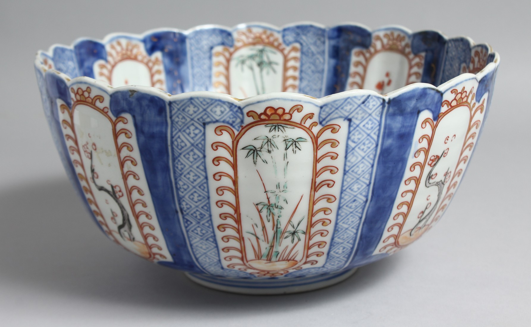 A JAPANESE IMARI PORCELAIN BLUE AND WHITE BOWL, with fluted-form, and decorated with panels of