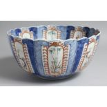 A JAPANESE IMARI PORCELAIN BLUE AND WHITE BOWL, with fluted-form, and decorated with panels of