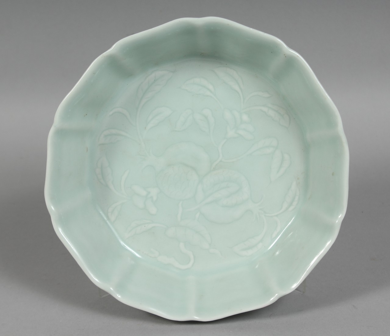 A CHINESE CELADON GLAZE PETAL FORM DISH, the centre with pomegranate decoration, six character