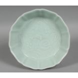 A CHINESE CELADON GLAZE PETAL FORM DISH, the centre with pomegranate decoration, six character