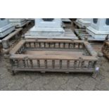 An Indian hardwood rectangular cradle or plant trough with turned spindle supports.