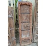 A pair of Indian carved hardwood doors with wrought iron mounts.