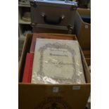 A box of bound sheet music.