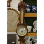 A large Victorian oak framed barometer / thermometer.