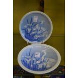 A pair of oriental blue and white plates, decorated with birds.