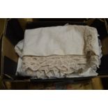 A box of white tablecloths, linen etc.