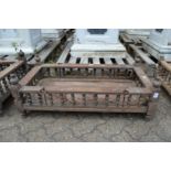 An Indian hardwood rectangular cradle or plant trough with turned spindle supports.