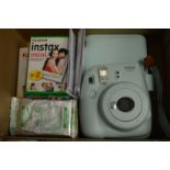 An Instax mini 9 camera etc.