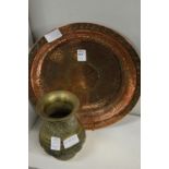 An Islamic copper dish and a cast brass vase.
