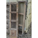 Two pairs of old Indian hardwood doors with wrought iron slats.