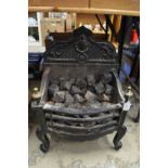 A Regency style cast iron fire grate.