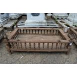 An Indian hardwood rectangular cradle or plant trough with turned spindle supports.