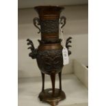 A Japanese Meiji period bronze tripod vase.