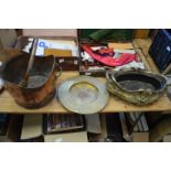 A copper coal scuttle, a brass dish and a cast metal jardiniere.