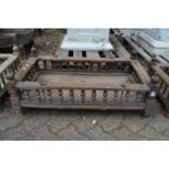 An Indian hardwood rectangular cradle or plant trough with turned spindle supports.