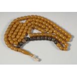AN AMBER BEADED NECKLACE, each bead approx. 8mm wide, necklace with a section of wood beads.