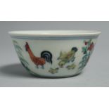 A CHINESE DOUCAI PORCELAIN CHICKEN CUP, the base six-character, 8cm diameter.