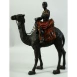 A MODEL OF A NUBIAN FIGURE RIDING A CAMEL, 38cm high.